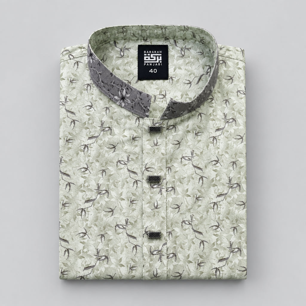 A folded men's kurta shirt with a light beige and green floral pattern, featuring a grey patterned inner collar and black brand tags.