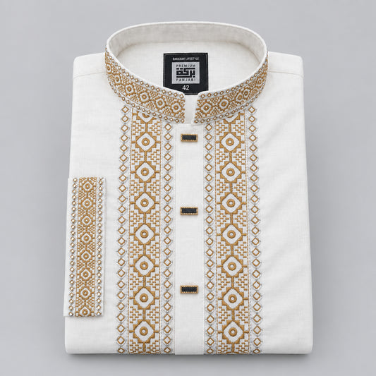 A folded white kurta with ornate gold geometric embroidery on the collar, placket, and sleeve cuff, featuring three decorative gold buttons, shown on a neutral gray background.