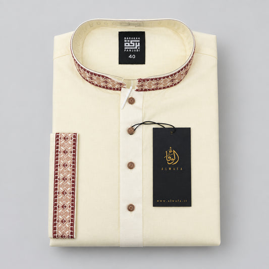 A folded cream-colored kurta with a mandarin collar and brown patterned trim, featuring a black hangtag with gold branding.