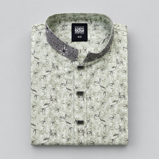 A folded men's kurta shirt with a light beige and green floral pattern, featuring a grey patterned inner collar and black brand tags.