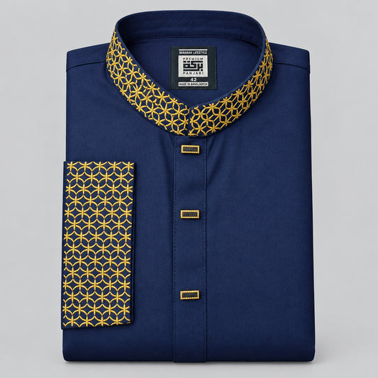 A folded navy blue shirt with a geometric yellow and black patterned collar and sleeve cuff, featuring a black brand label at the inner collar.