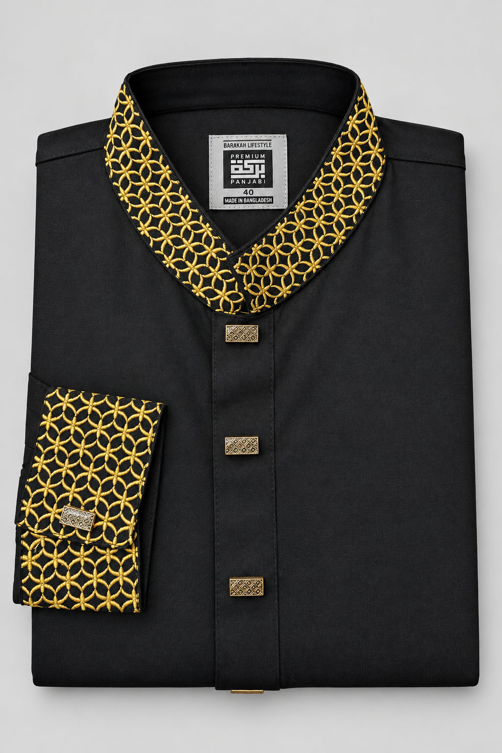 A folded black long-sleeve shirt with a mandarin collar and a matching patterned cuff, featuring a yellow and black geometric print on the collar and cuff, and gold-tone buttons.