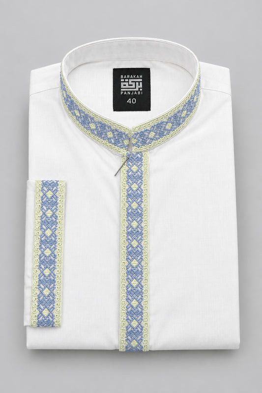 A folded white kurta shirt with blue and yellow patterned trim, featuring a mandarin collar and a black hangtag, displayed on a dark blue surface.