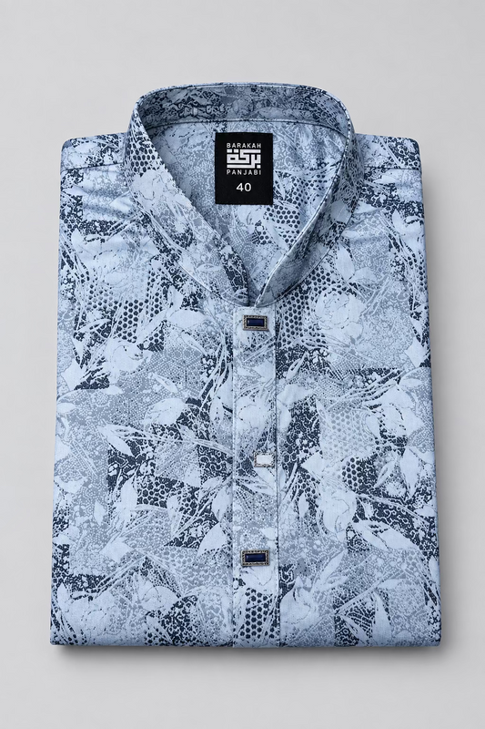 A folded men's long-sleeve shirt with a black and white abstract pattern, featuring a black neck label that reads 'BESPOKE PARACHUT' and '40', and a black hangtag with a gold logo.