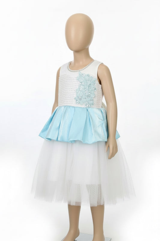 A sleeveless girls' dress displayed on a mannequin against a plain white studio background. The dress has a white textured bodice with a light blue floral applique and a light blue peplum, paired with a layered white tulle skirt.